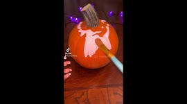 I’m using craft smart acrylic paint to create a Kirby pumpkin.