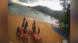 Beachgoers narrowly avoid roof blown off by powerful wind