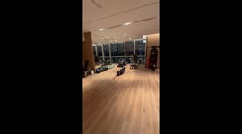 Man practices freestyle swimming on shiny hardwood floor