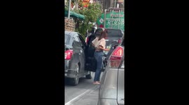 Drivers use bottles of drinking water to douse flames on burning motorycle