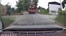 Tractor falls off car carrier and rolls backwards down road