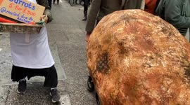 Extinction Rebellion march with a giant potato on second day of their three-day insurance protest in London