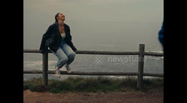 Couple Nearly Falls When Fence Breaks at Edge of Cliff