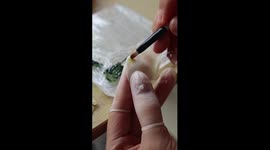 Artisan crafts realistic rose from clay