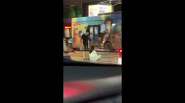 Dramatic tourist sits in the middle of road while arguing with boyfriend