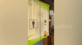 Public toilet has incredible view of beautiful sunrise overlooking mountain village