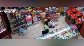 Giant rat creeps up little girl's blouse while she plays on the floor