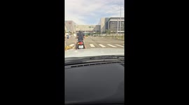 Scooter rider struggles to control bike and crashes into lamppost