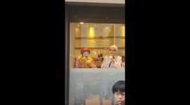 Ronald McDonald and Colonel Sanders cosplay duo together in fast food outlet