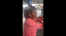 Woman Dances While Balancing a Bottle on Her Head