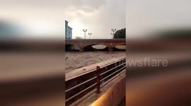 Muddy torrents surge through river amid DANA storm in Spain