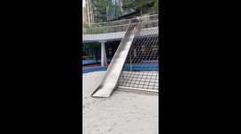 Corgi slides down children's slide with playful landing in Beijing