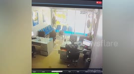 Out-of-control car crashes into office as employee sits at front desk