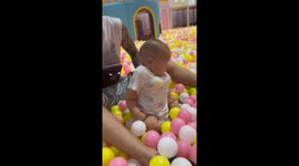 Baby resembles body builder with plastic balls stuffed under vest
