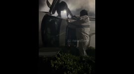 Passerby helps people from car that crashed and flipped over in China