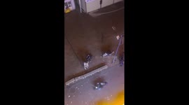 Accidental hero! Scooter rider crashes into rowing men... inadvertently stopping fight