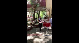 School children surprise their teacher with a pet chicken as a gift