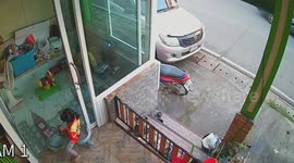 Fearless toddler swings from house gate over steps
