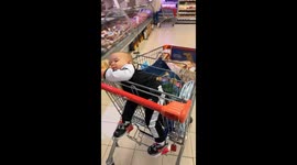 Baby lies on loaf of bread and eats it in Belgrade supermarket