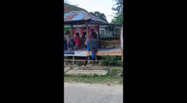 Children in Indonesia run from rooster chasing them