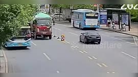 Lucky schoolgirl runs into road and dodges bus but gets hit by truck