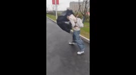 Student battles wind during Typhoon Connie in China