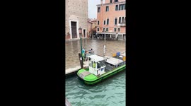 Only in Venice. This is how Venice keeps its cleanses by using boats to collect trash.