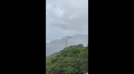 Strong winds leave zip line tourist stranded 300ft above ground