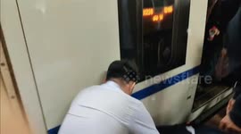 Heroic passenger risks life by crawling under train to save little boy who fell from station platform