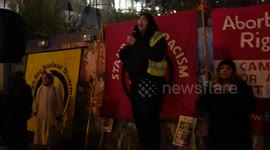 A speaker from the activism group Stand Up To Racism speaks on stage to roughly 50 people at a protest against President Donald Trump being elected. The protest was held outside the US Embassy in Nine Elms, London