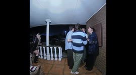 Friend slips on porch as friends rush to help