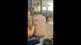 Watch how this artist paints a landscape on ceramic wine vat