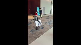 Robot boy shakes hands with convention visitors