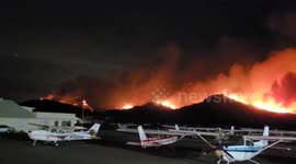 Raging mountain fire threatens airport in California