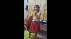 Little girl dances with her pet parrot