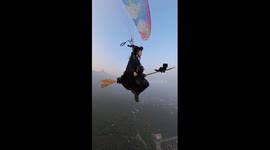Paraglider in witch costume appears to be flying on broomstick