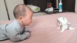 Child observes crawling toy in Shandong China