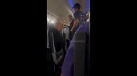 Man had to be escorted off of flight from Cancun to Pheonix after trying to open emergency exit door of plane
