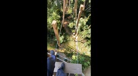Man crosses rotating steps on high bridge in Foshan, China