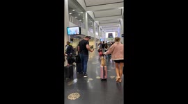 Chihuahua Rides Through Airport on Suitcase