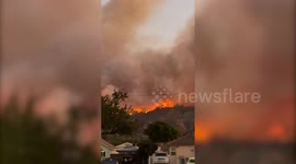 Video shows California wildfire burning near homes