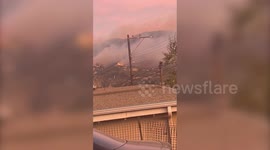 Video shows California wildfire burning near homes