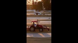 Farmers sun-dry harvested rice grains in E China