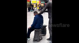 Chinese locals turn bronze statue into impromptu masseur, using its hands for shoulder and neck massages in quirky viral trend