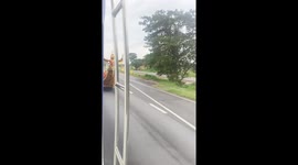 Motorised boat cruises along highway in Thailand