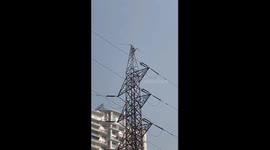 Resident sparks panic by climbing electricity pylon in India