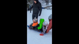Parents can only watch as their kids sledding downhill collide with other children