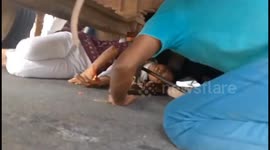 Indian politician and locals rescue woman trapped under a truck