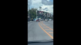 Reckless rider hangs sideways from motorcycle