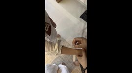 Chinese woman and young boy create beautiful flower bracelets in Jiangsu